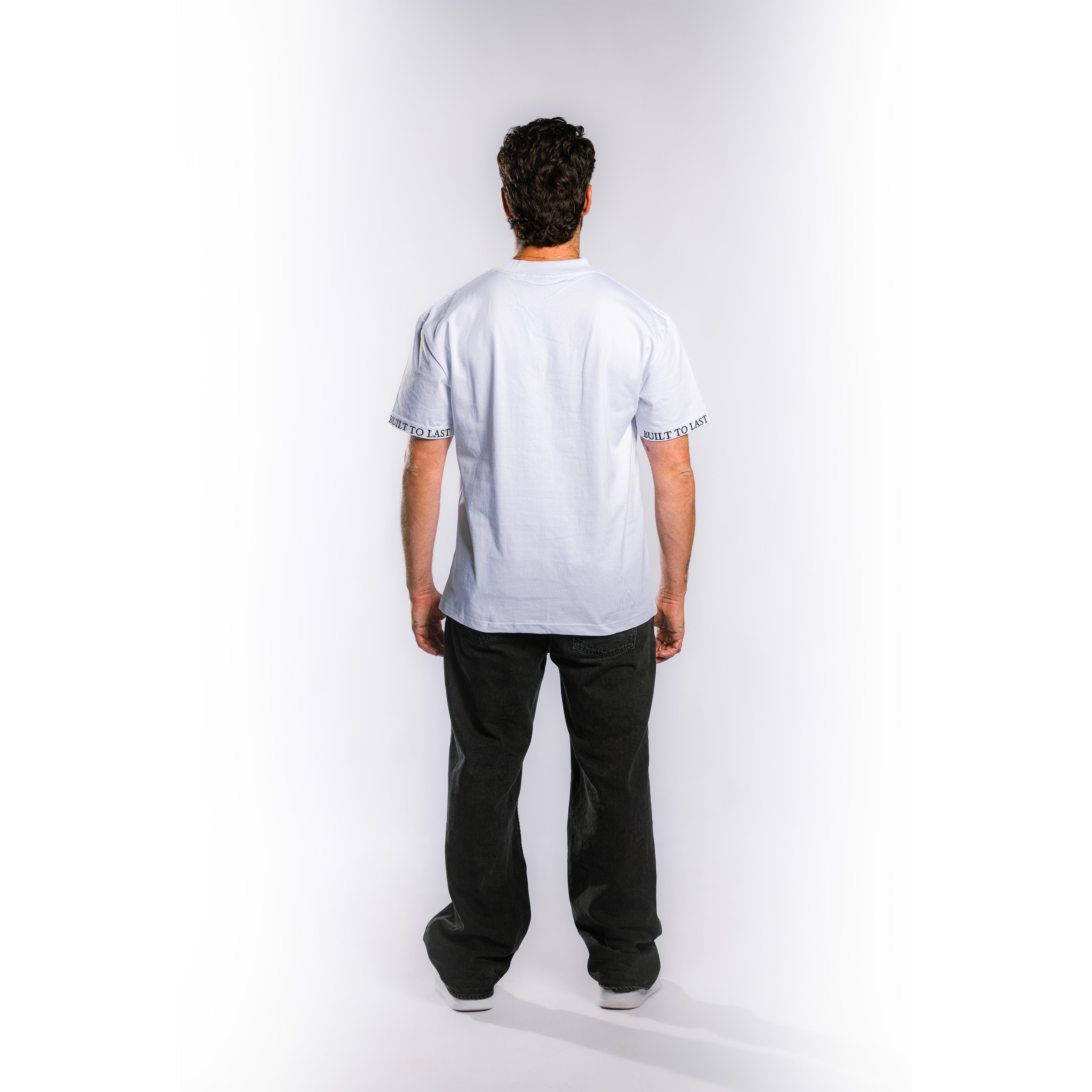 Back view of model wearing Built to Last Monolith Tee White heavyweight cotton T-shirt with minimalist oversized fit