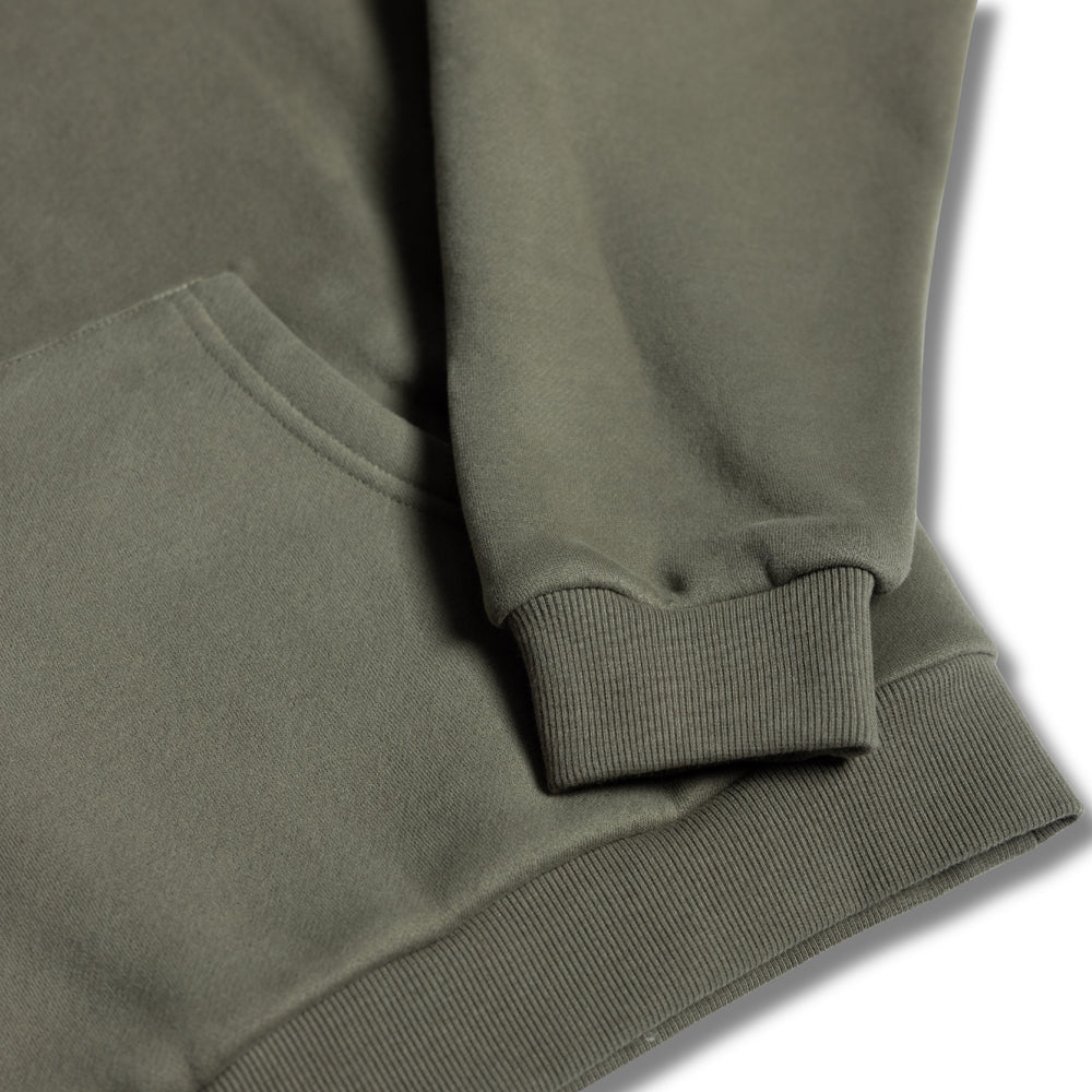 Close-up detail of ribbed cuff and hem on women's olive relaxed fit hoodie by Built To Last.