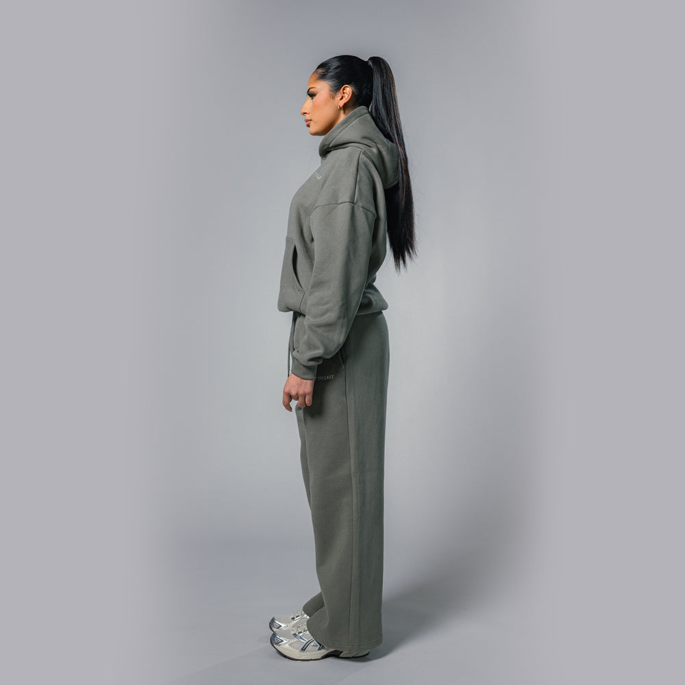 Side view of women's olive relaxed fit tracksuit set by Built To Last.