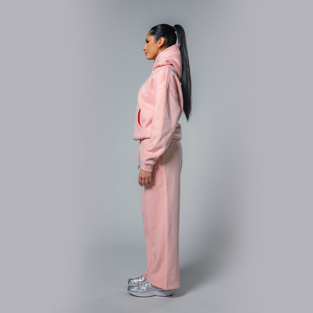 Side view of women's light pink relaxed fit tracksuit set by Built To Last.