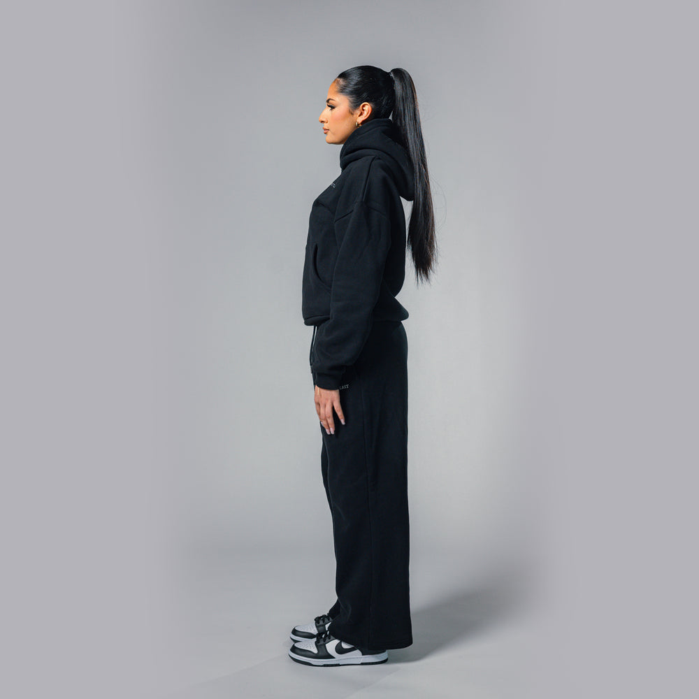 Side view of women's black relaxed fit tracksuit set by Built To Last.