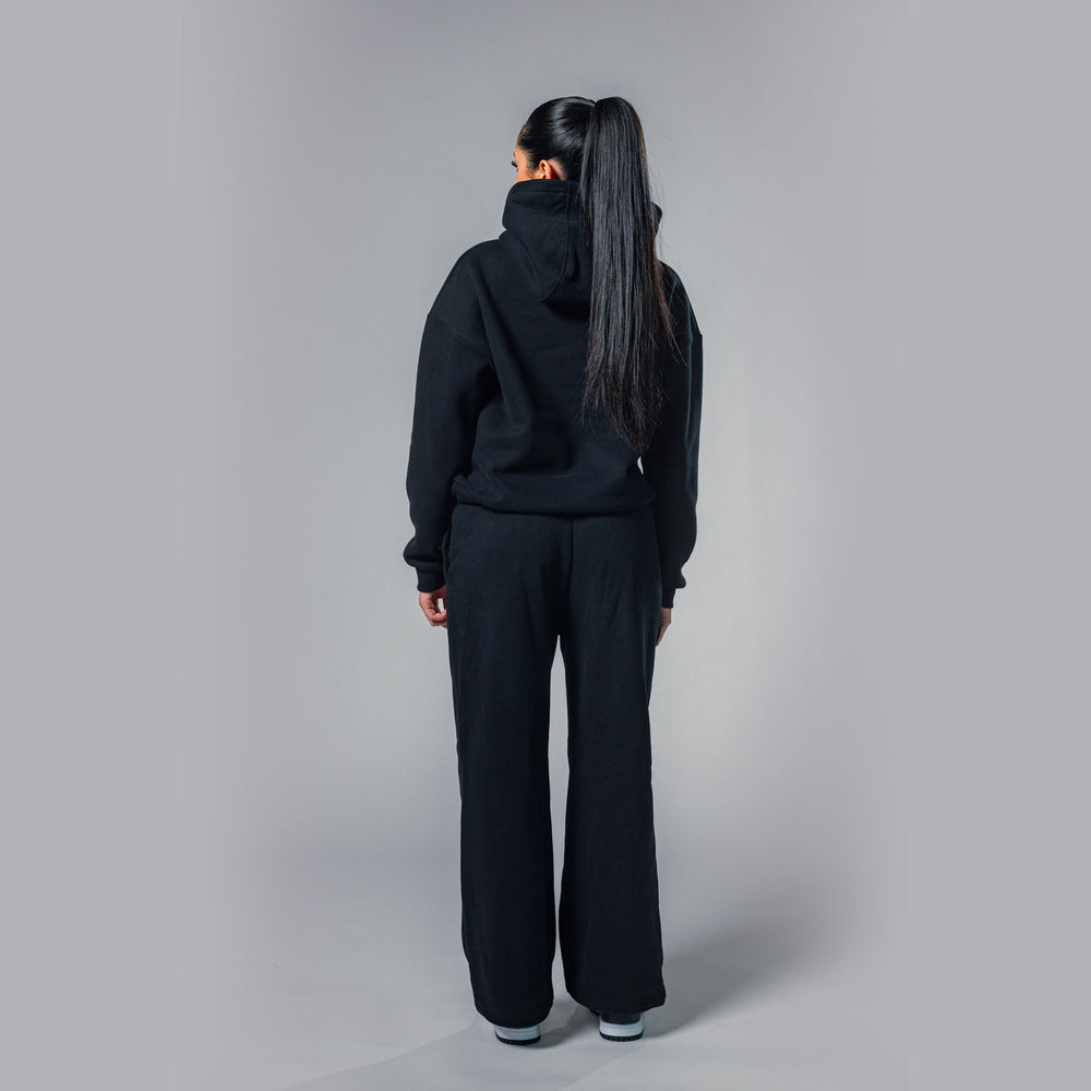 Back view of women's black relaxed fit tracksuit set by Built To Last.