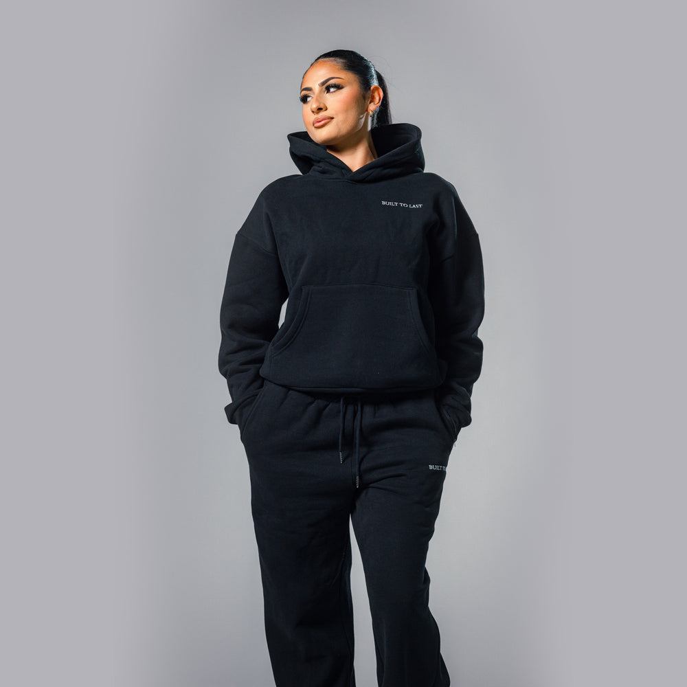 Women's black relaxed fit hoodie and sweatpants tracksuit set by Built To Last.