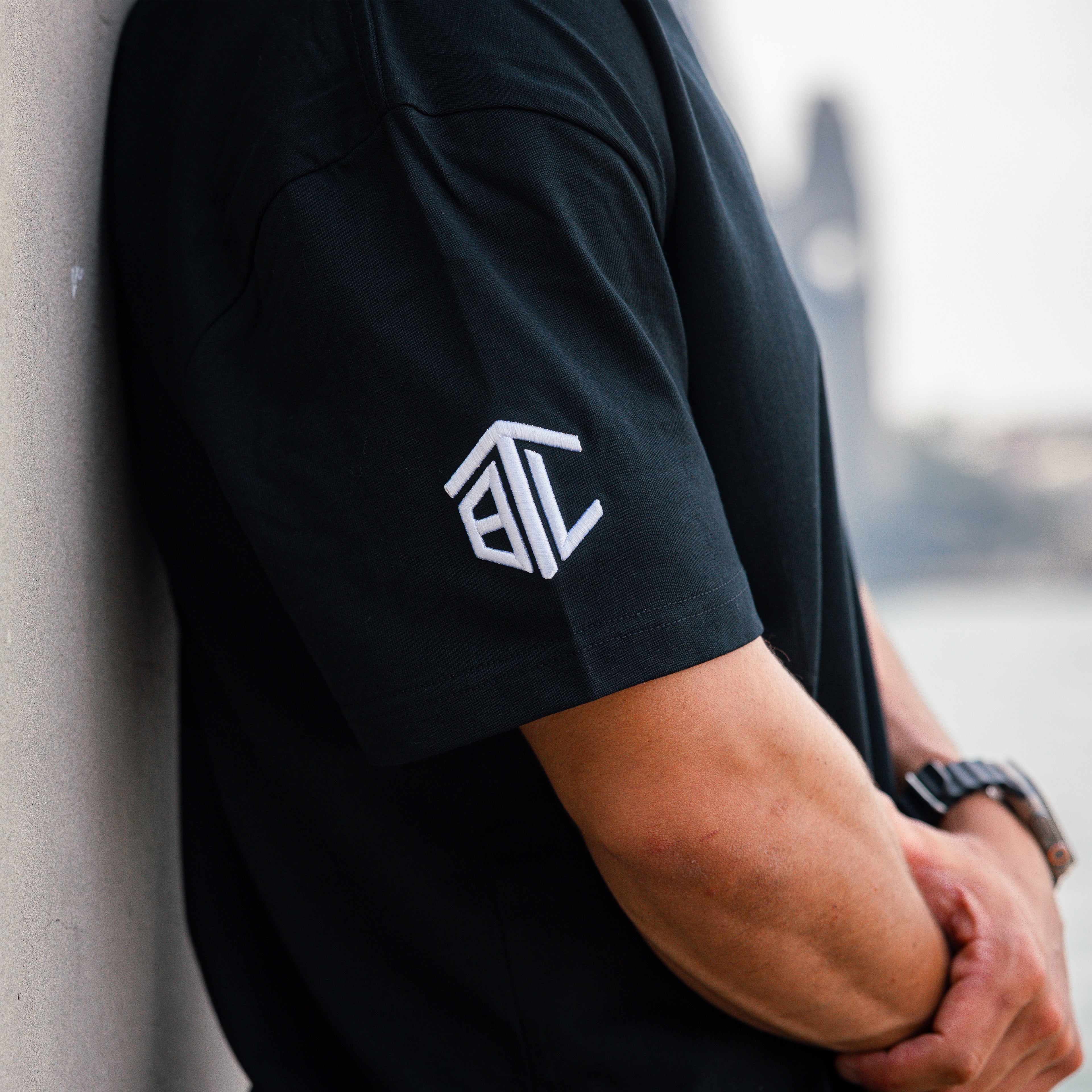 Close-up of Built to Last Legacy Tee Black embroidered sleeve logo on premium heavyweight cotton T-shirt