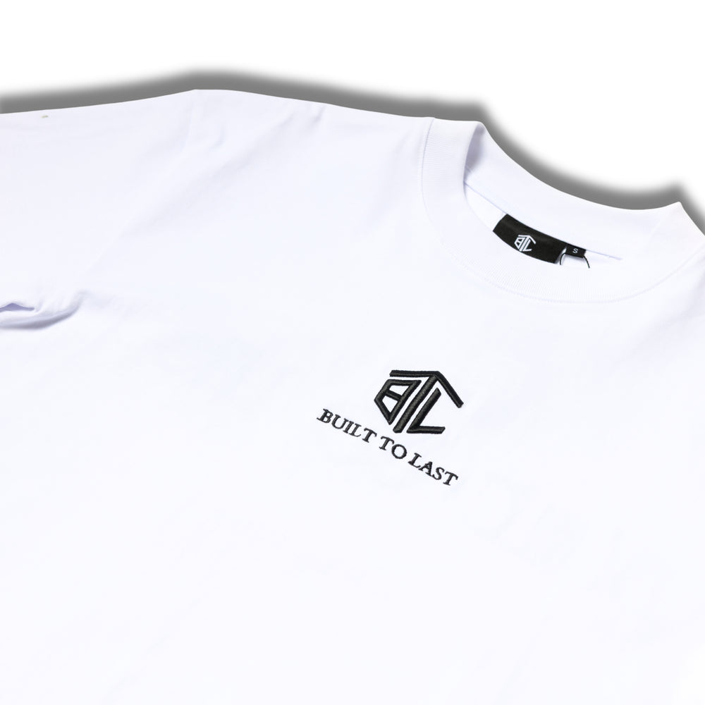 Close-up of Built to Last Eternal Tee White embroidered chest logo on premium heavyweight cotton T-shirt