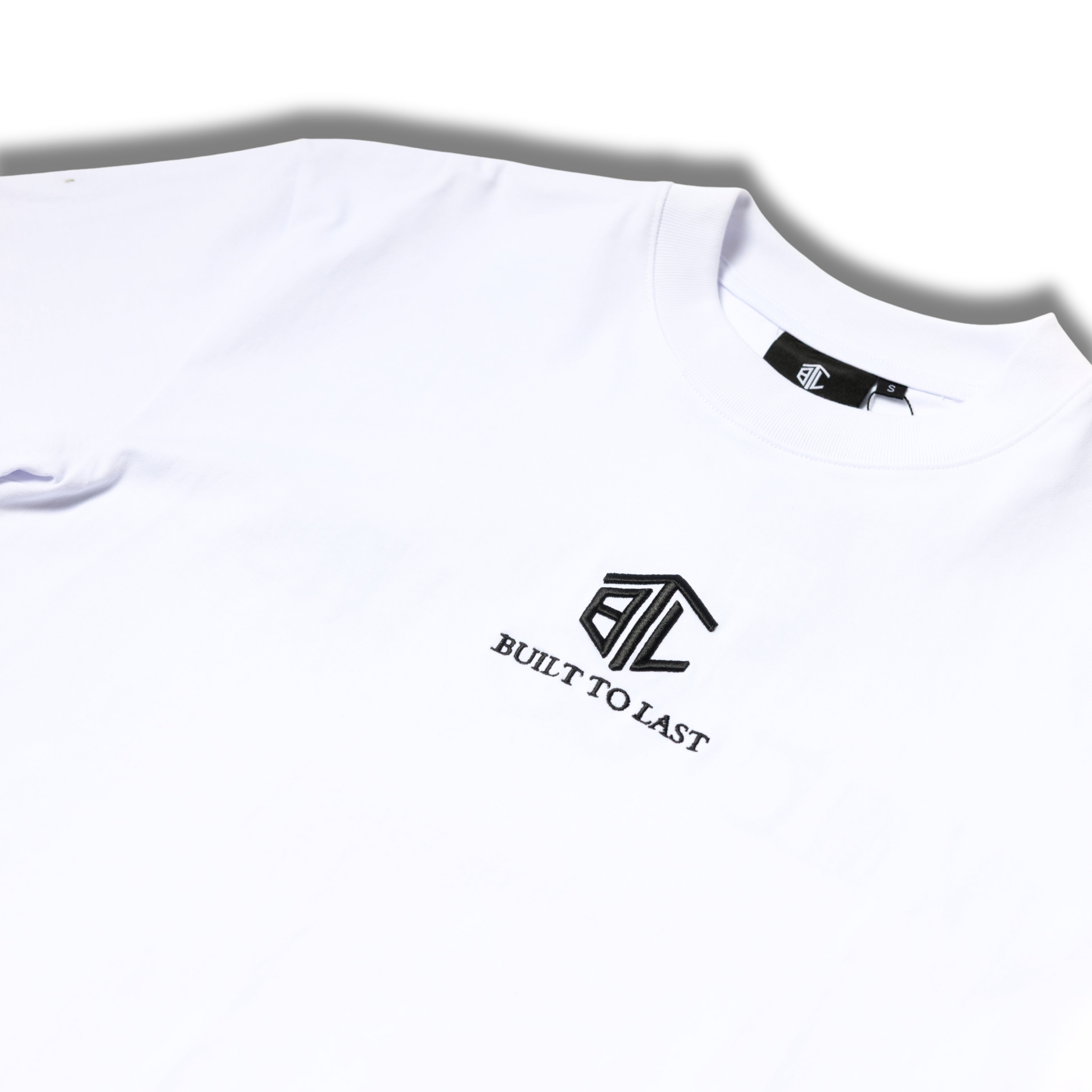 Close-up of Built to Last Eternal Tee White embroidered chest logo on premium heavyweight cotton T-shirt