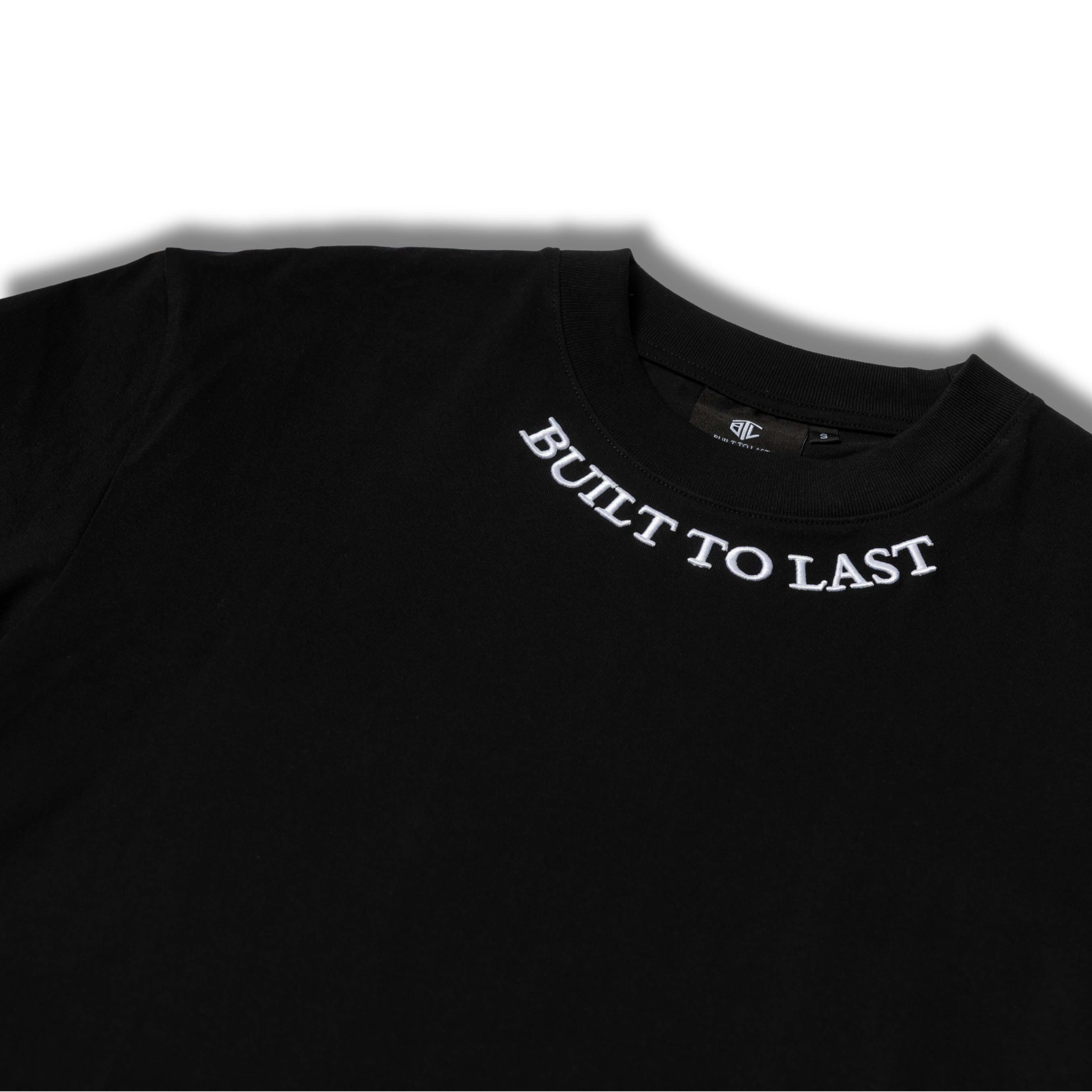Black t-shirt with 'BUILT TO LAST' text on a white background