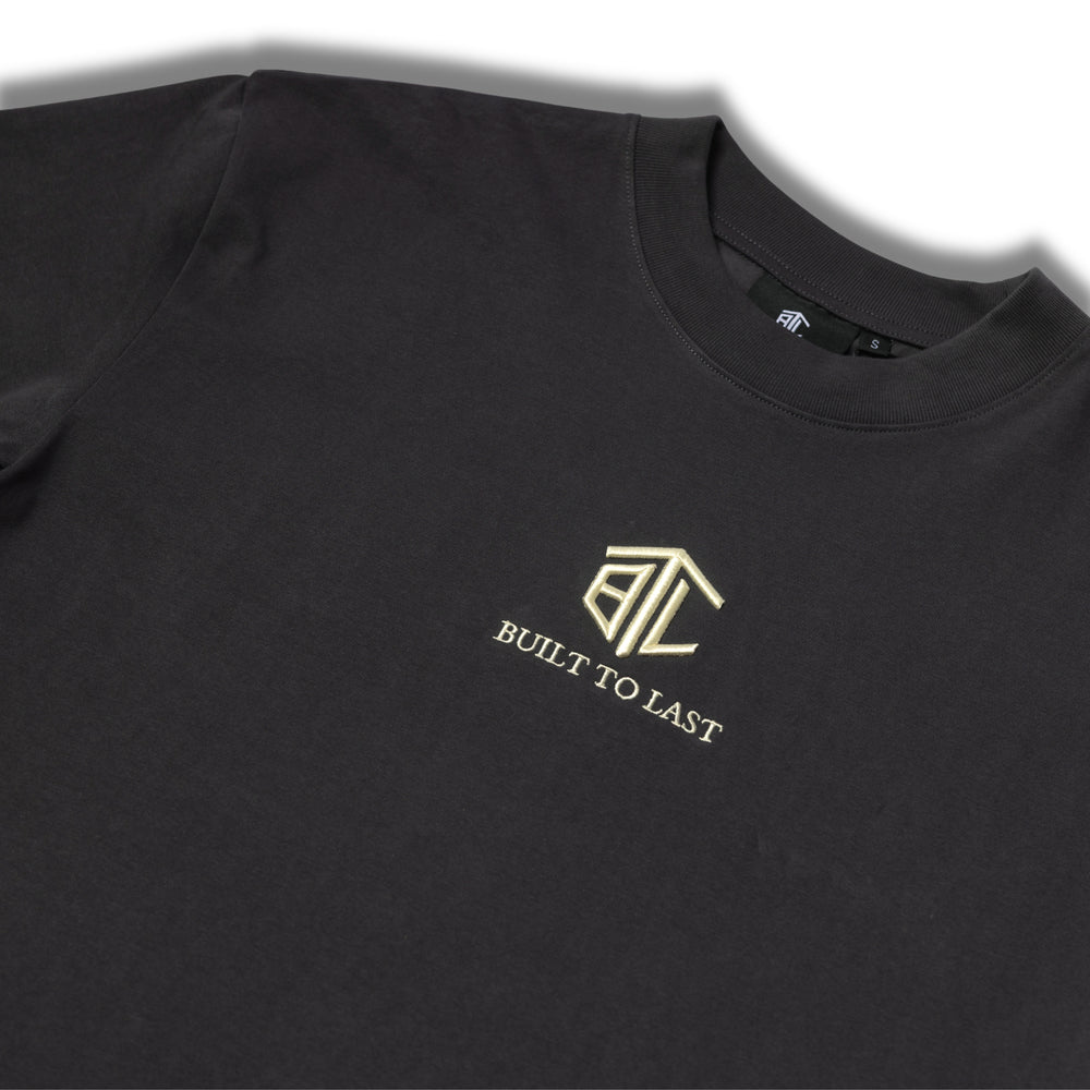 Close-up of Built to Last Eternal Tee Granite embroidered chest logo on premium heavyweight cotton T-shirt