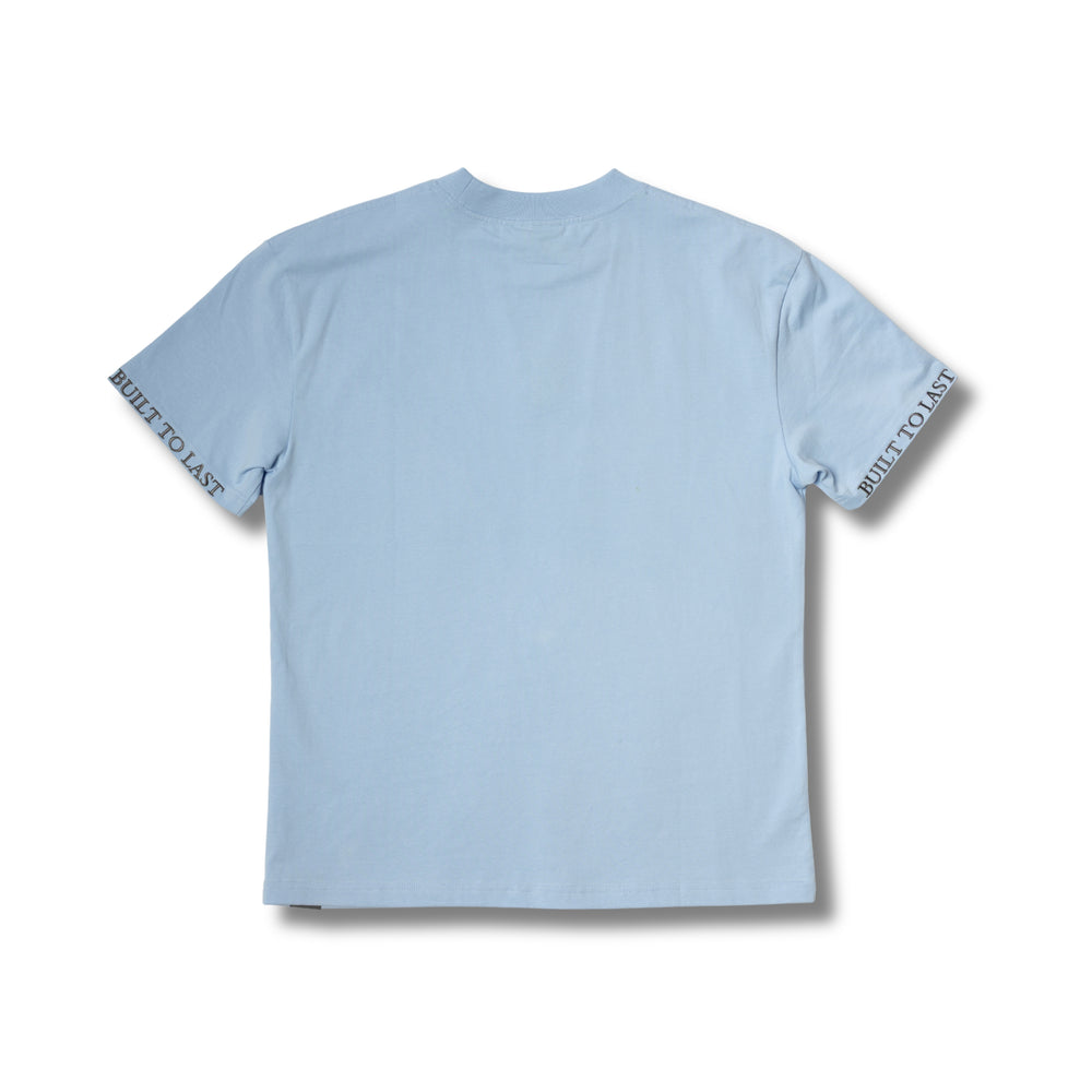 Back view of Built to Last Monolith Tee Blue heavyweight cotton T-shirt with minimalist design and branded sleeve print