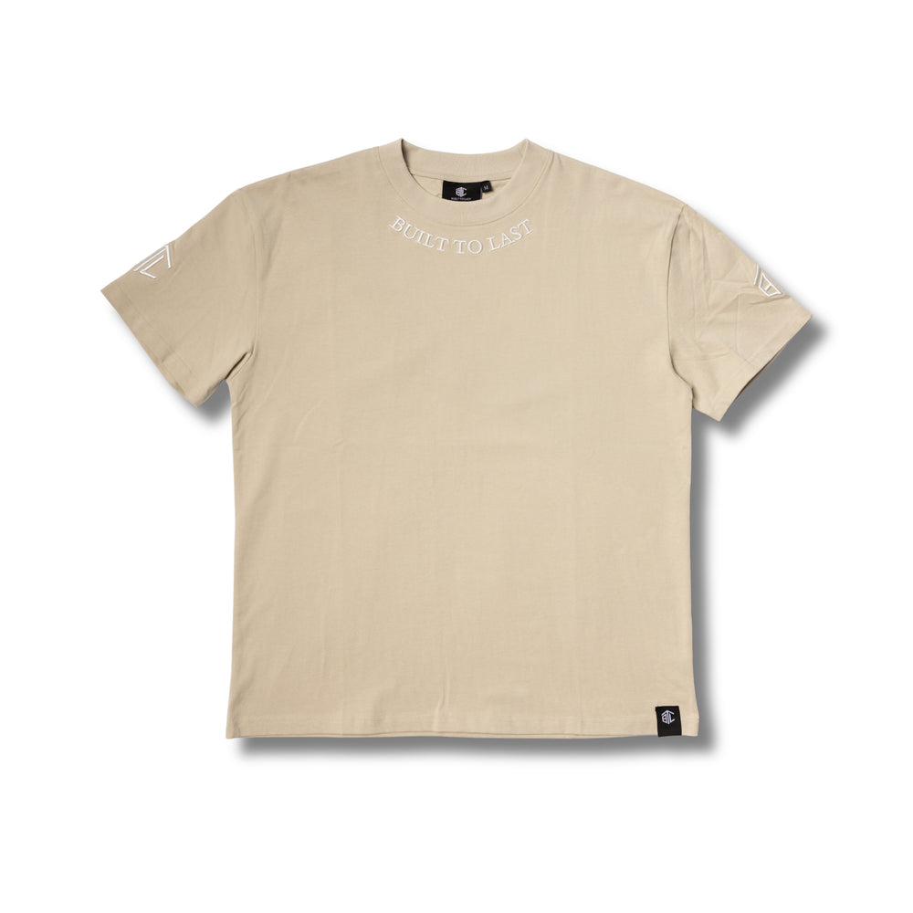 Front view of Built to Last Legacy Tee Champagne heavyweight cotton T-shirt with embroidered neckline logo and minimalist design