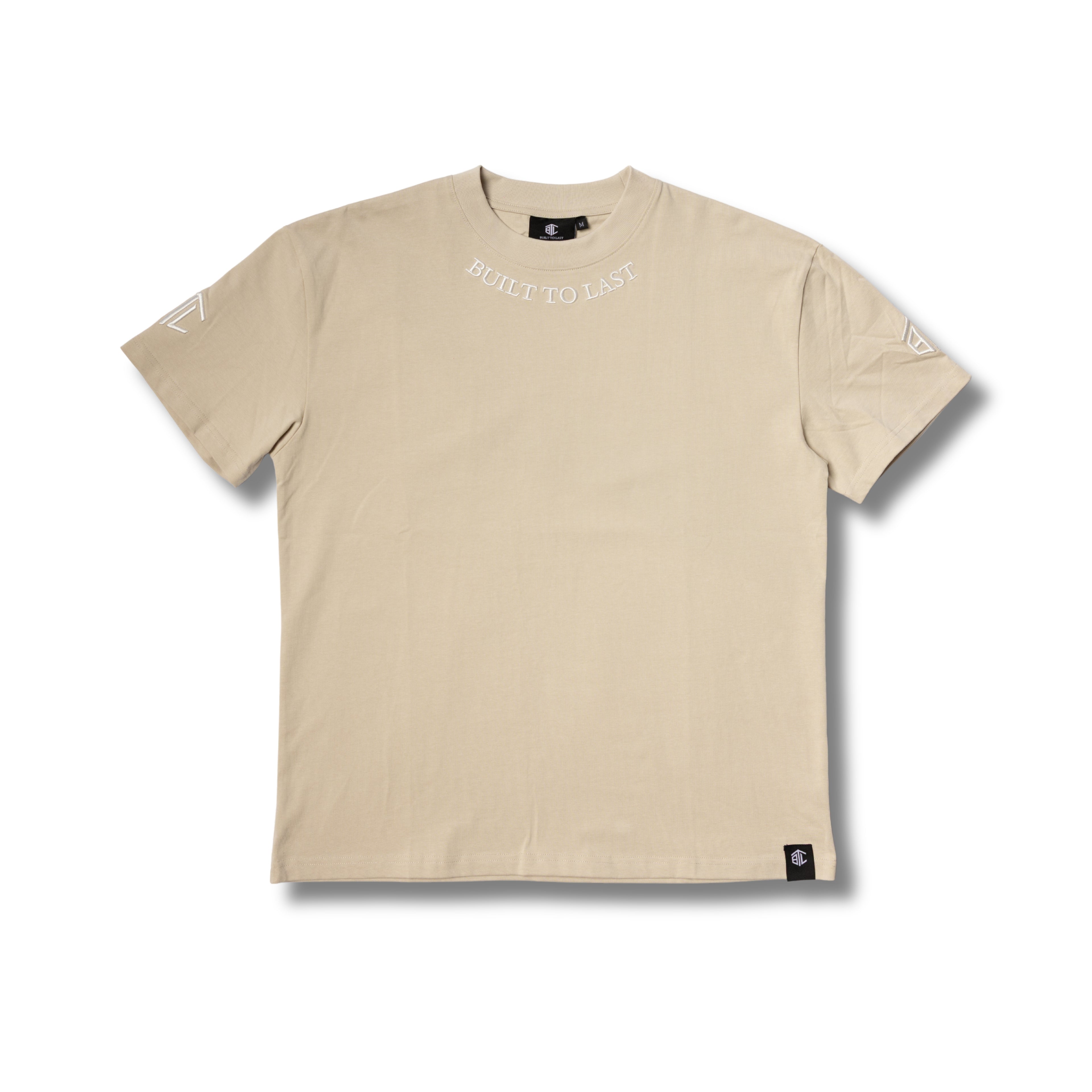 Front view of Built to Last Legacy Tee Champagne heavyweight cotton T-shirt with embroidered neckline logo and minimalist design