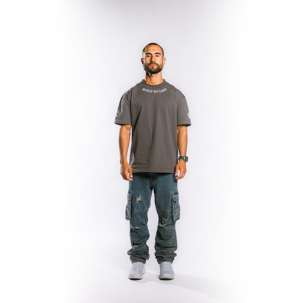 Front view of model wearing Built to Last Legacy Tee Stone heavyweight cotton T-shirt with relaxed oversized fit