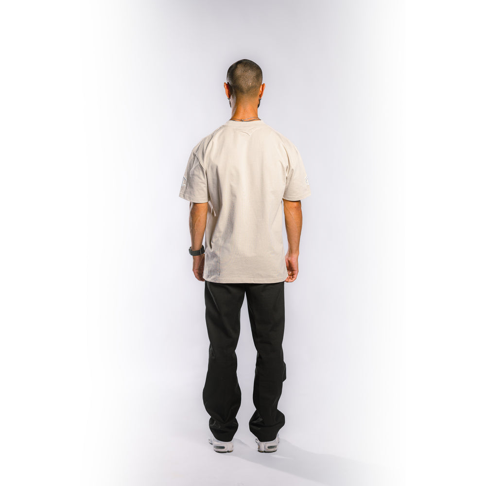 Back view of model wearing Built to Last Legacy Tee Champagne heavyweight cotton T-shirt with minimalist streetwear design