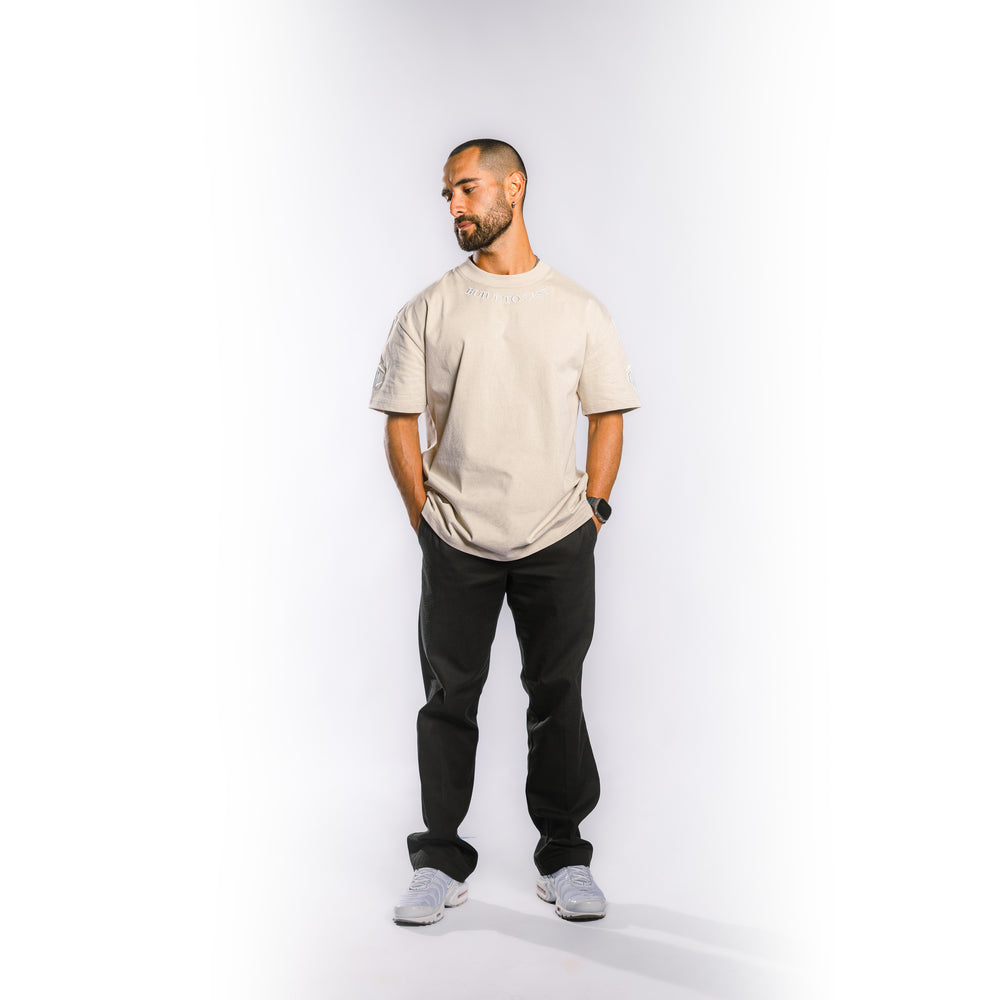 Model wearing Built to Last Legacy Tee Champagne heavyweight cotton T-shirt in relaxed everyday streetwear style