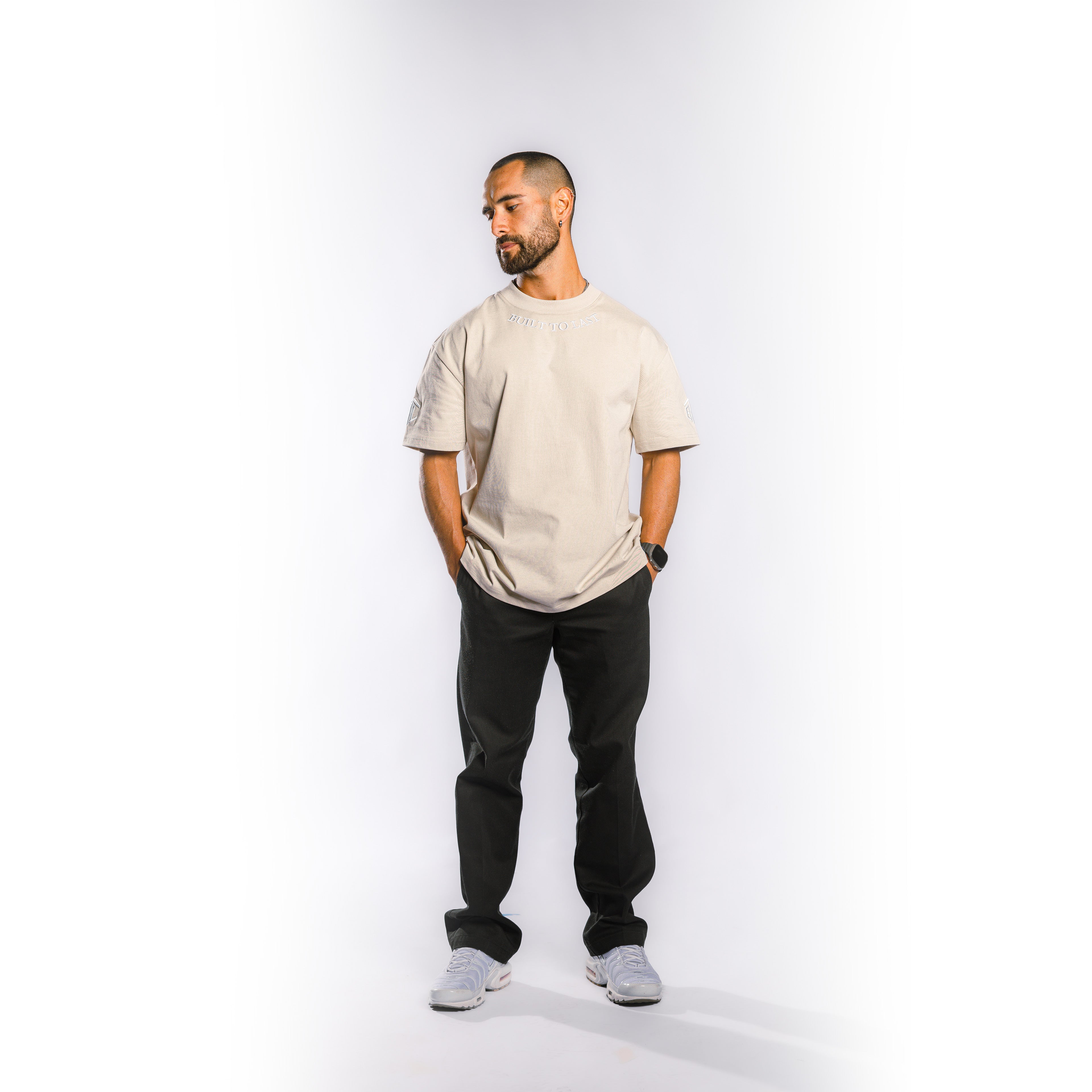 Model wearing Built to Last Legacy Tee Champagne heavyweight cotton T-shirt in relaxed everyday streetwear style
