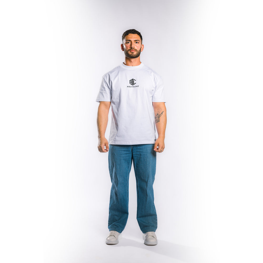 Front view of model wearing Built to Last Eternal Tee White heavyweight cotton T-shirt with embroidered chest logo