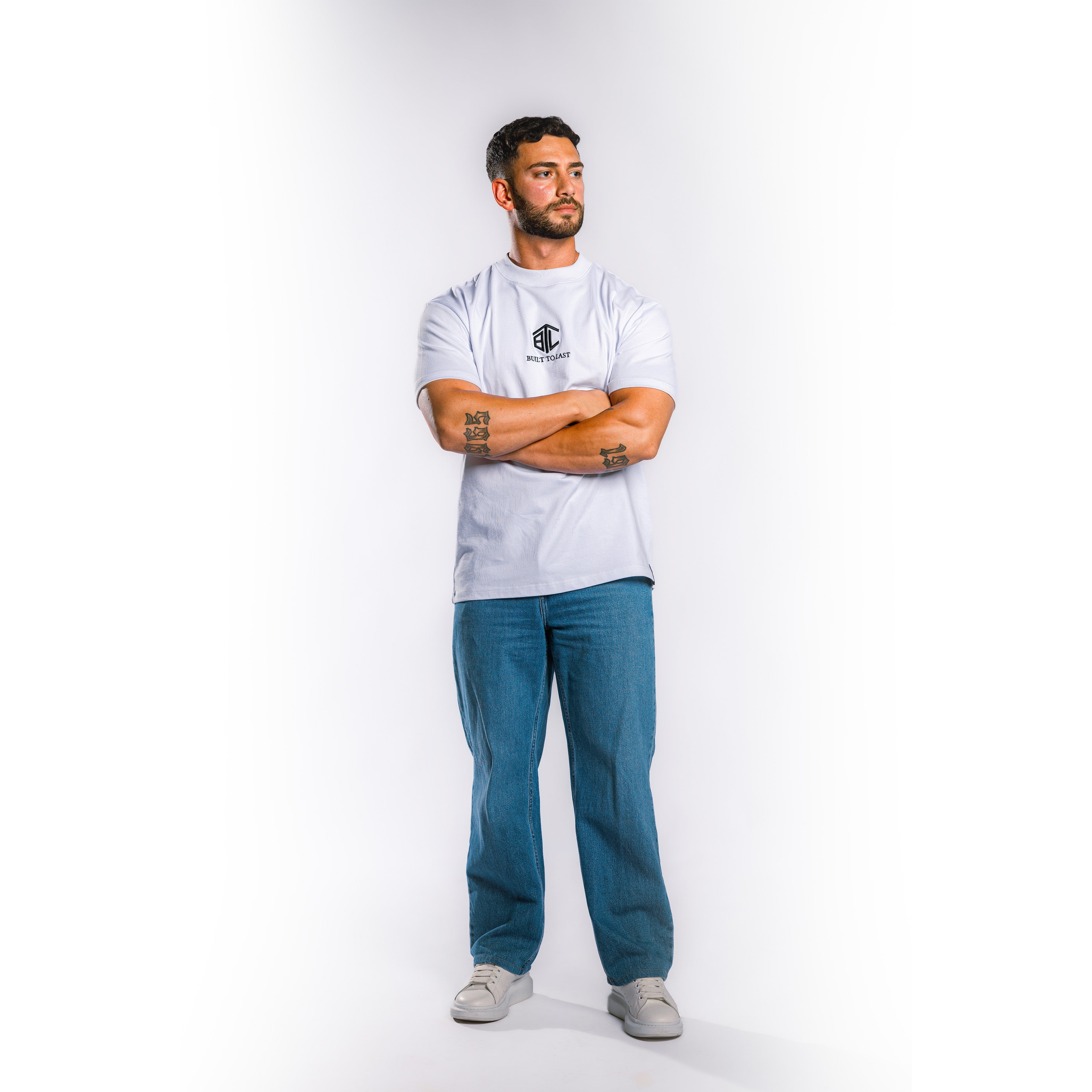 Front view of model wearing Built to Last Eternal Tee White heavyweight cotton T-shirt with embroidered chest logo