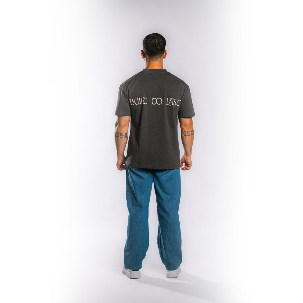 Back view of model wearing Built to Last Eternal Tee Granite heavyweight cotton T-shirt with oversized Built to Last back graphic