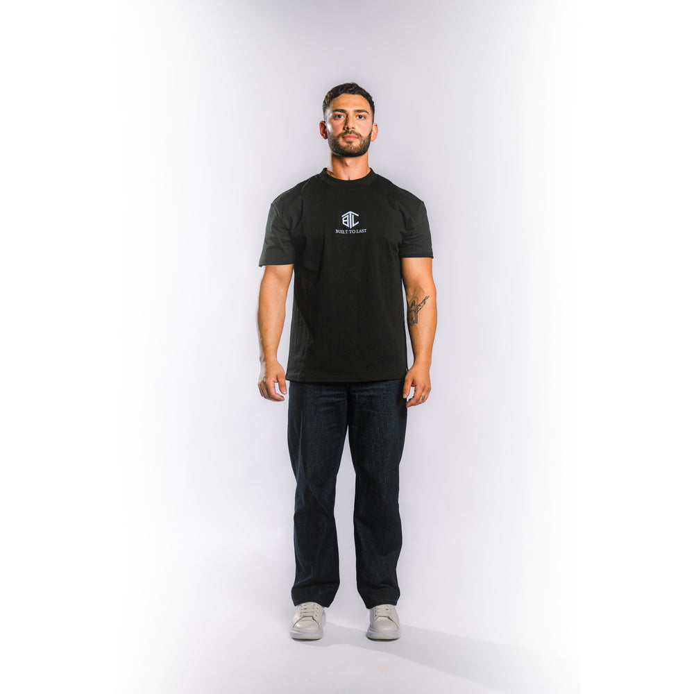 Front view of model wearing Built to Last Eternal Tee Black heavyweight cotton T-shirt with embroidered chest logo